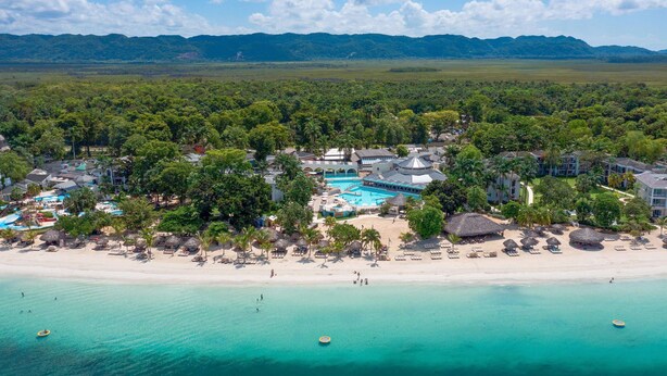 A resort with a swimming pool, beach, and lush greenery. - Beaches Negril Resort - ALL INCLUSIVE (Negril)
