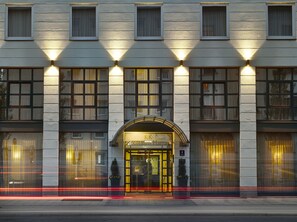 Fachada clásica de hotel, con amplias ventanas y una entrada destacada.