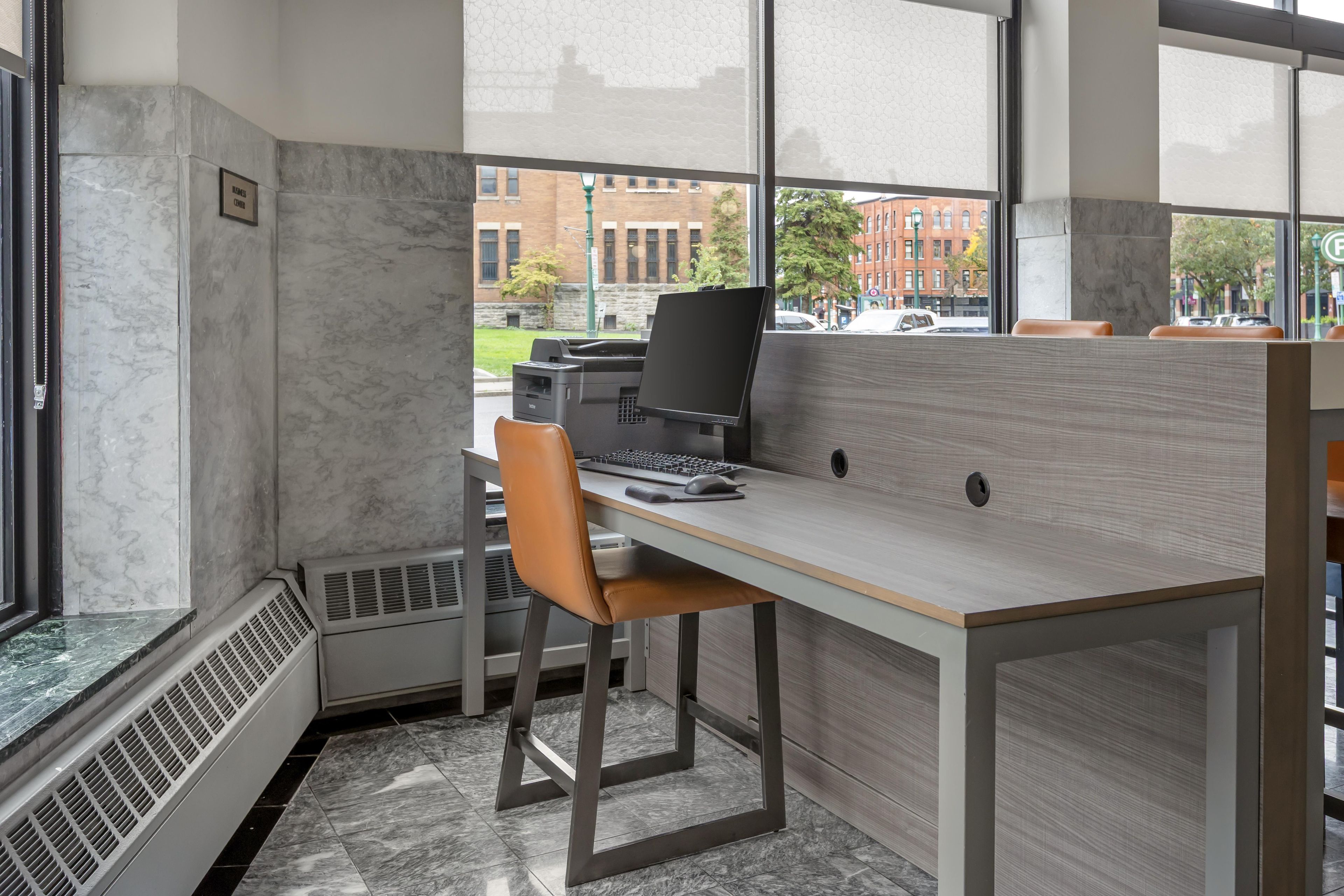 A modern office cubicle with a desk, chair, and computer.