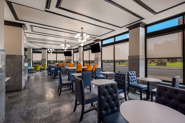Enjoy meals in a stylish dining area with tables, chairs, and flat-screen TVs.