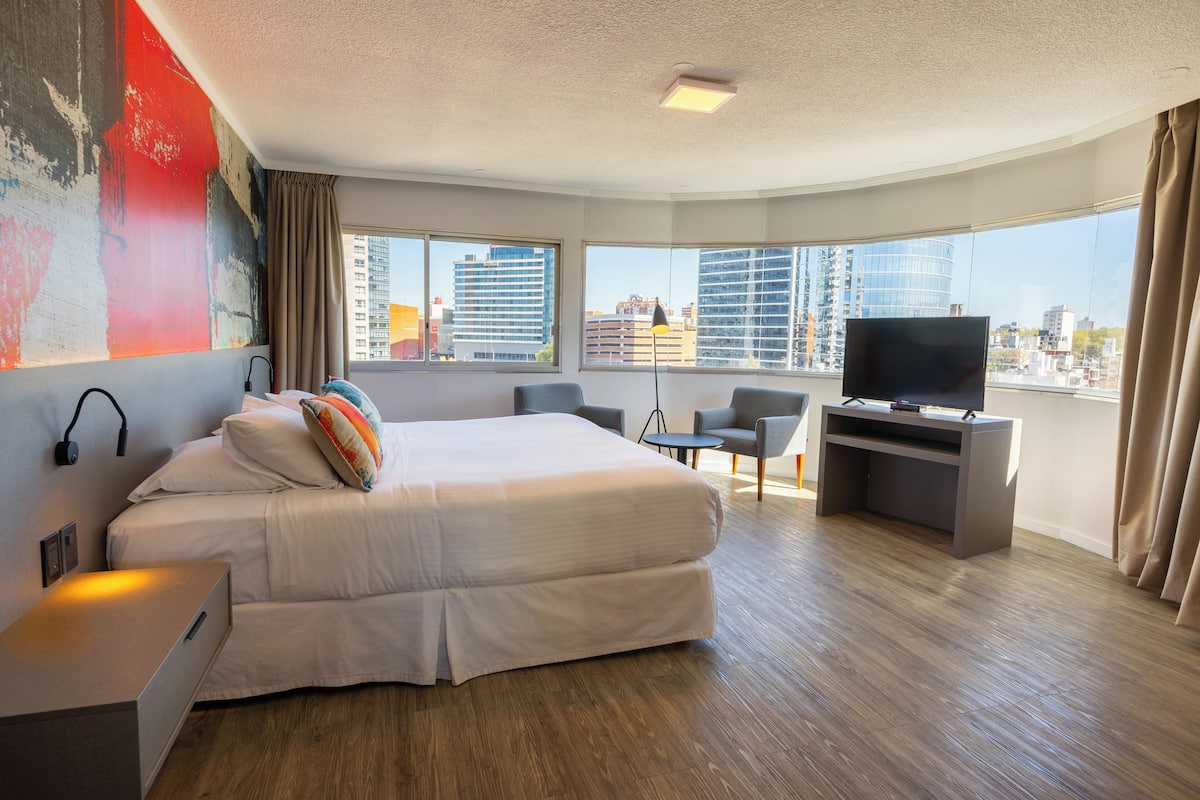 Suite, 1 King Bed, Corner | Minibar, in-room safe, desk, iron/ironing board