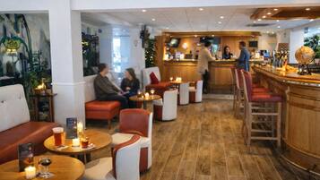 A cozy bar area with seating and a bar counter.