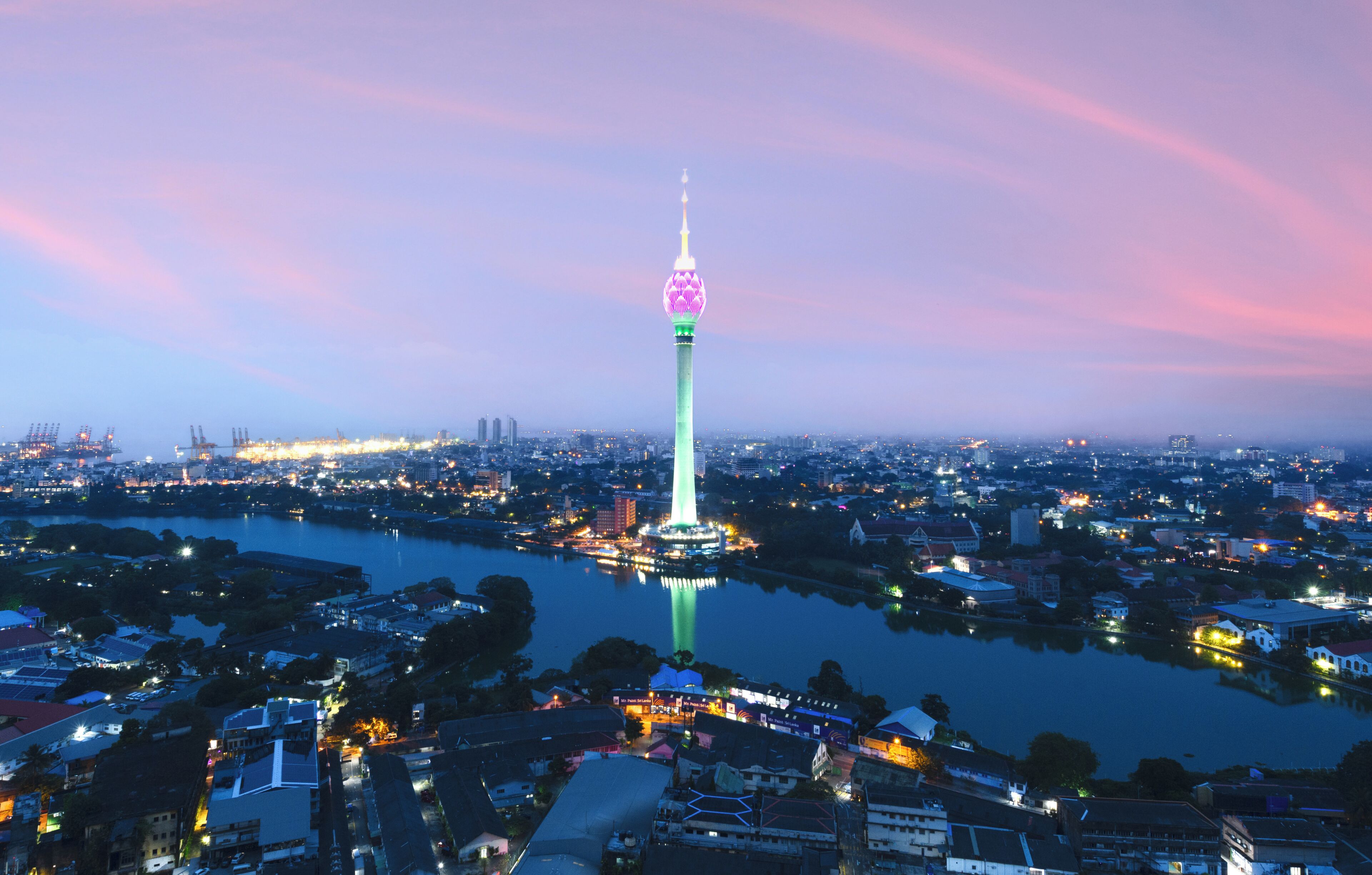 A cityscape with a prominent tower, a river, and surrounding buildings.