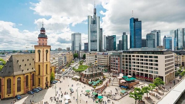 A cityscape with a mix of historic and modern architecture, including a prominent church and high-rise buildings.