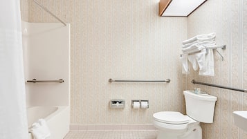 Ein Badezimmer mit Dusche, Toilette und Handtuchhalter.