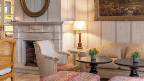A well-appointed living room with a fireplace, comfortable seating, and a large painting on the wall. - Hotel Lisboa Plaza, a Lisbon Heritage Collection (Lisbon)