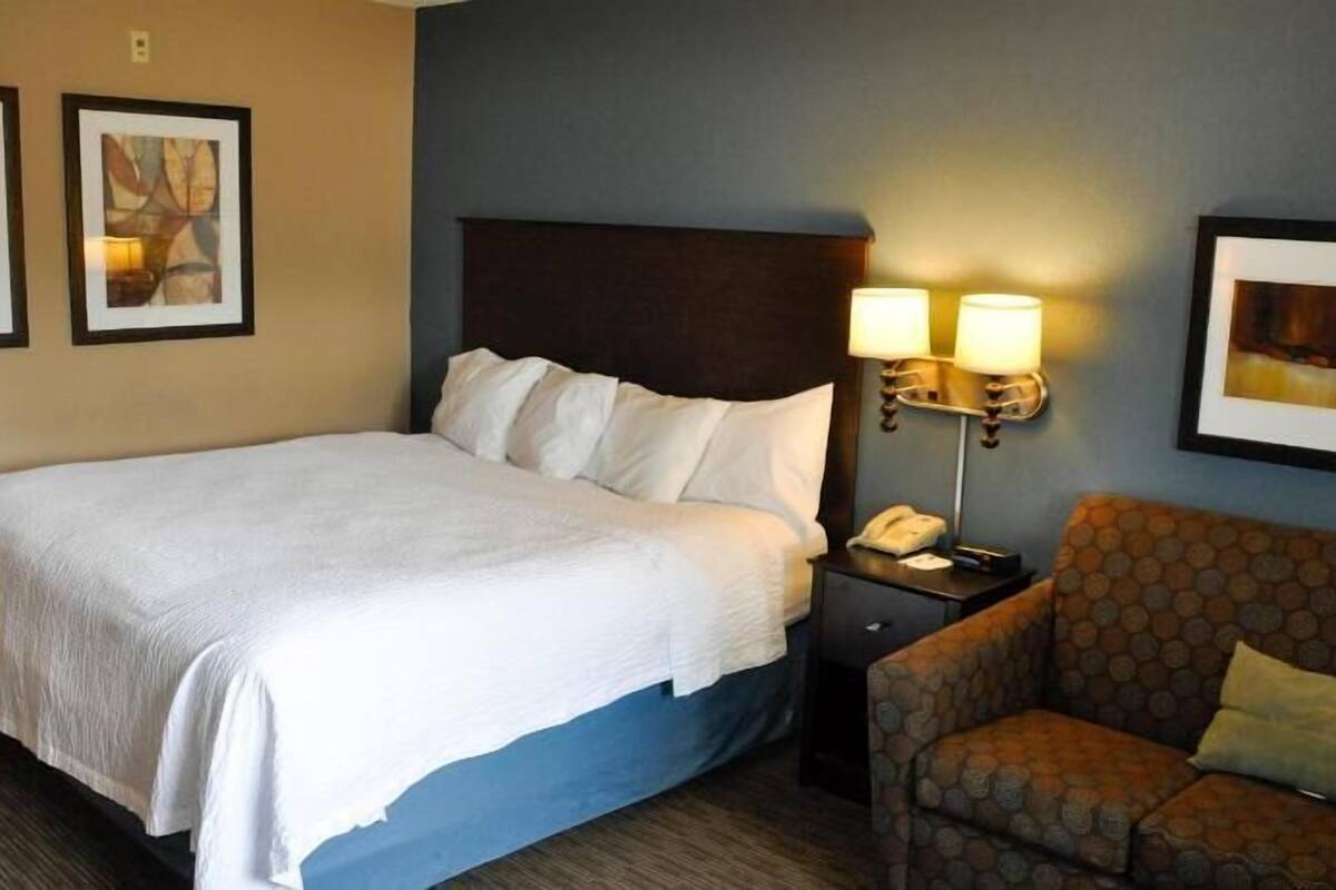 Desk, laptop workspace, blackout drapes, iron/ironing board