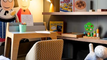 Work and play come together in this inviting space with a desk, chair, and a collection of board games and educational toys.
