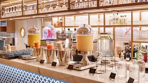 A bar area with various beverages and a coffee machine. - Radisson Hotel Aix en Provence (Aix-en-Provence)