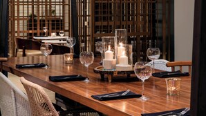 A dining table set with candles, glasses, and napkins. - Renaissance Fort Lauderdale Marina Hotel (Fort Lauderdale)