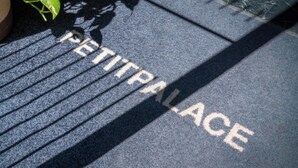 A textured surface with the words 'PETIT PALACE' embossed in a light color.