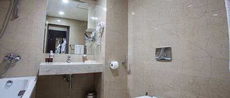 Un baño moderno con bañera, lavamanos e inodoro.