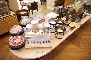 A buffet with various food items and utensils.