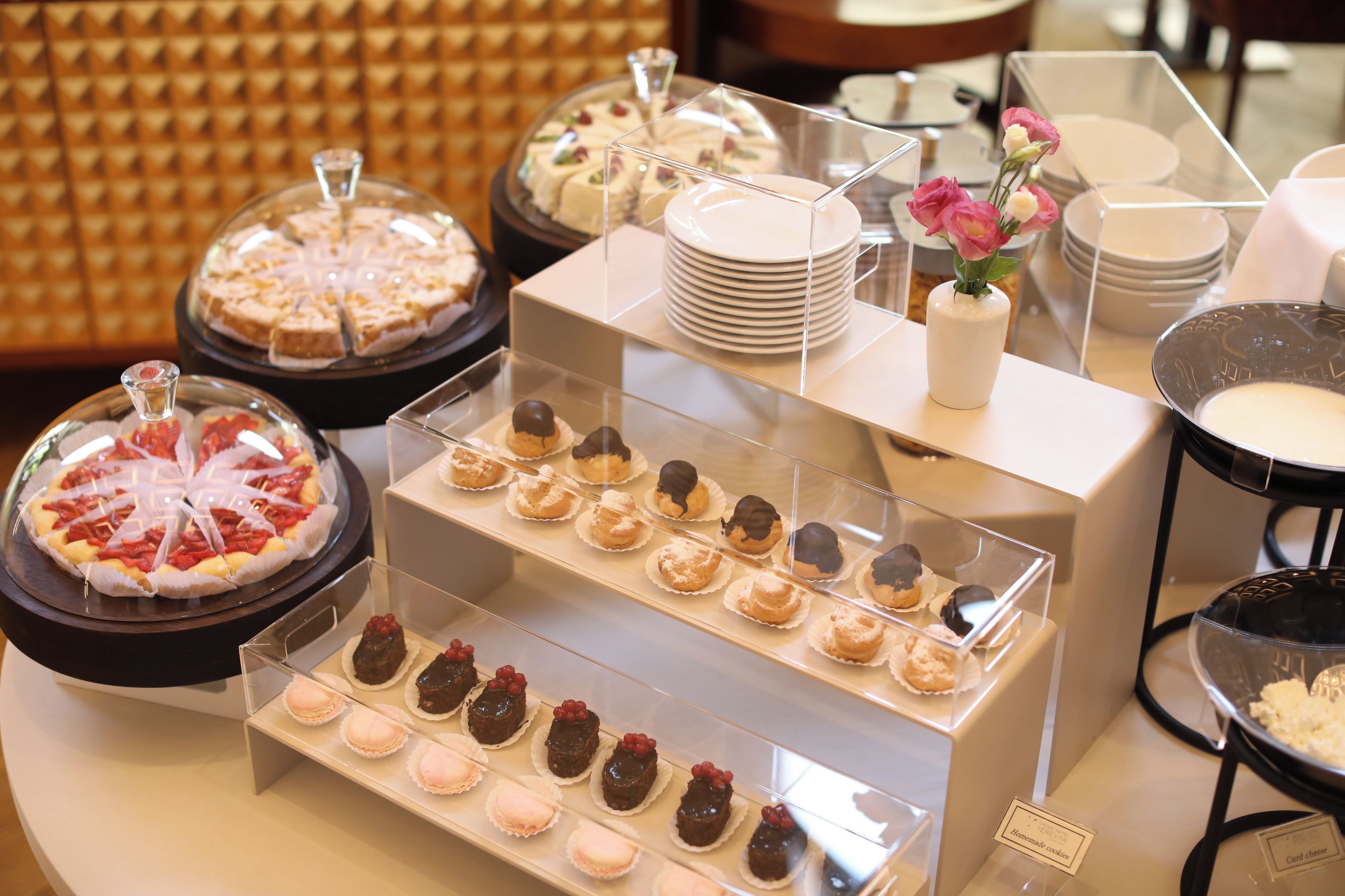 A dessert display with various pastries and cakes.