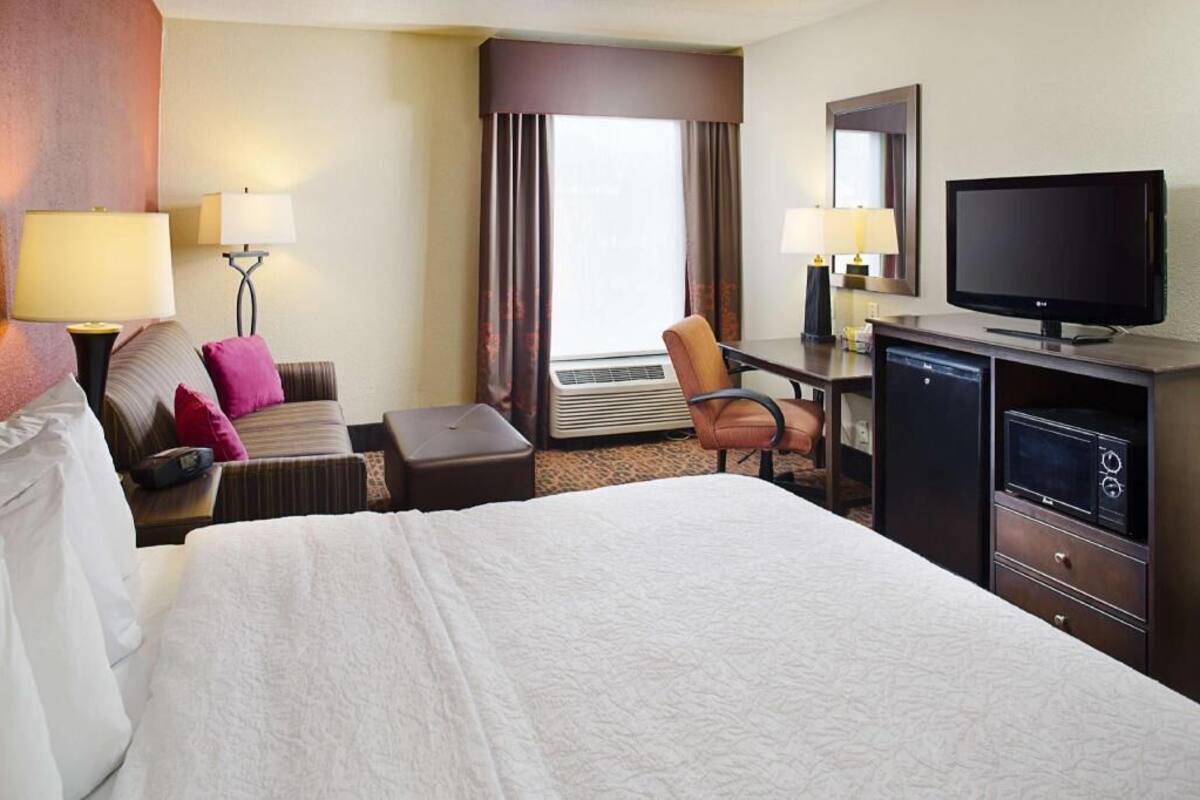 Premium bedding, desk, laptop workspace, blackout drapes