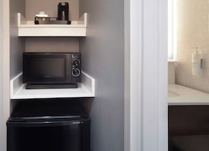 A compact kitchen with a microwave, a coffee maker, and a trash bin. - Hampton Inn & Suites Atlanta Airport North I-85 (Atlanta)