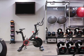 A gym with an exercise bike, dumbbells, and exercise balls. - Hampton Inn & Suites Atlanta Airport North I-85 (Atlanta)
