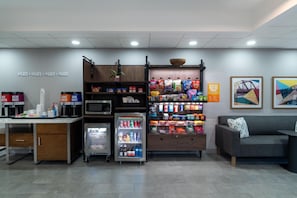 A kitchenette area with a coffee machine, microwave, and beverage dispenser. - Hampton Inn Marietta (Marietta)