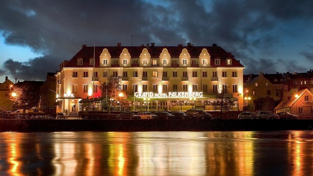 A hotel with a traditional European architectural style, featuring multiple stories and a prominent entrance.
