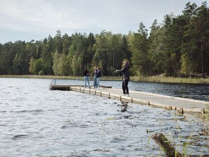 A wooden dock extending into a lake surrounded by dense forest. - Quality Hotel Winn Haninge (Handen)