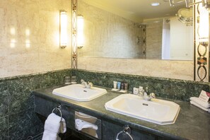 Une salle de bain avec deux lavabos, un porte-serviettes et un miroir.
