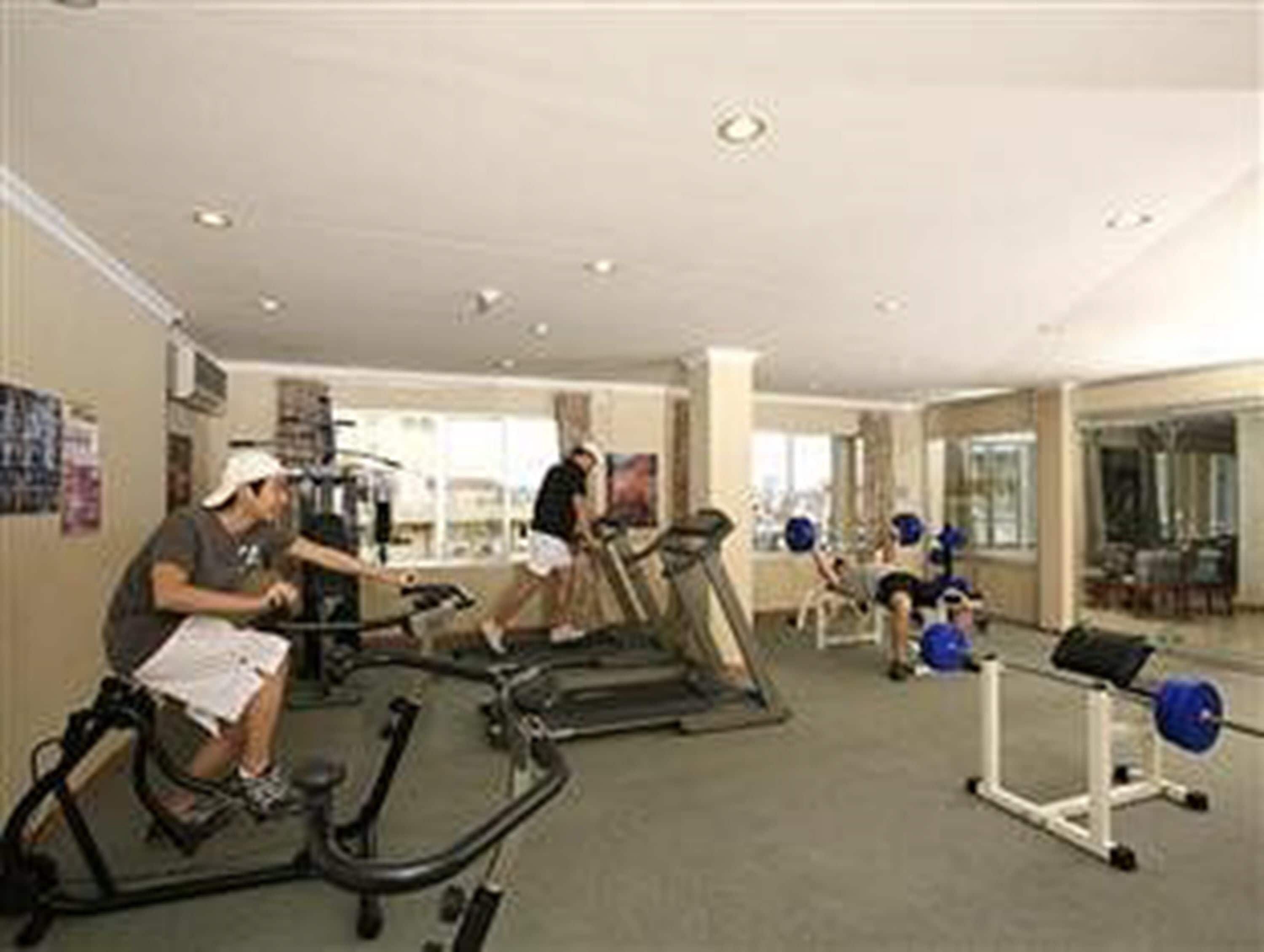 A gym with treadmills, stationary bikes, and weight machines.