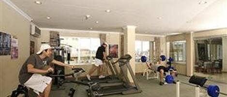 A gym with treadmills, stationary bikes, and weight machines.