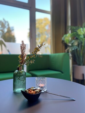 Enjoy a serene atmosphere with a view of the surrounding trees from the comfort of this cozy space.