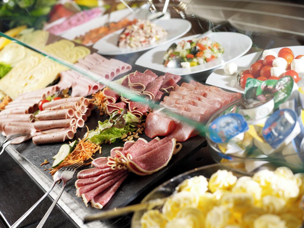 A variety of food items displayed on a buffet table.