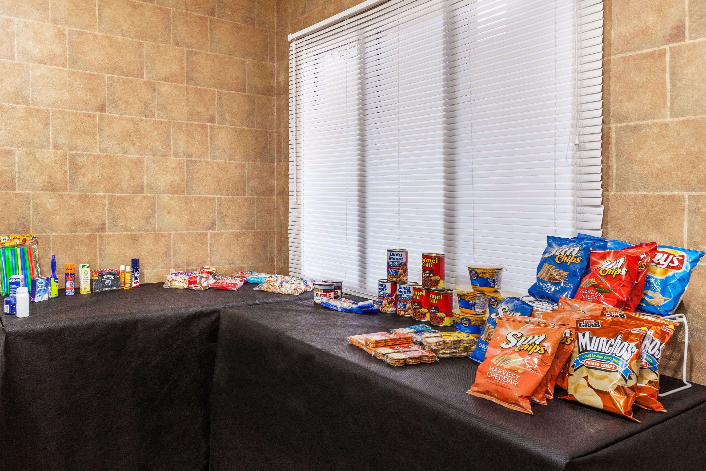 A table with various snacks and beverages.