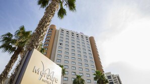 A hotel building with a sign reading 'Mermaid Hotels,' surrounded by palm trees. - Mercure Alger Aeroport (Algiers)
