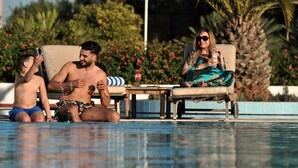 A pool area with lounge chairs and a child playing in the water. - Mercure Alger Aeroport (Algiers)