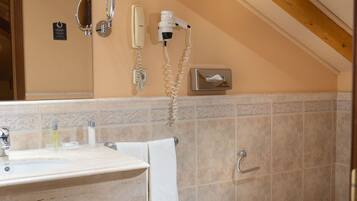 A bathroom with a sink, bidet, and toilet.