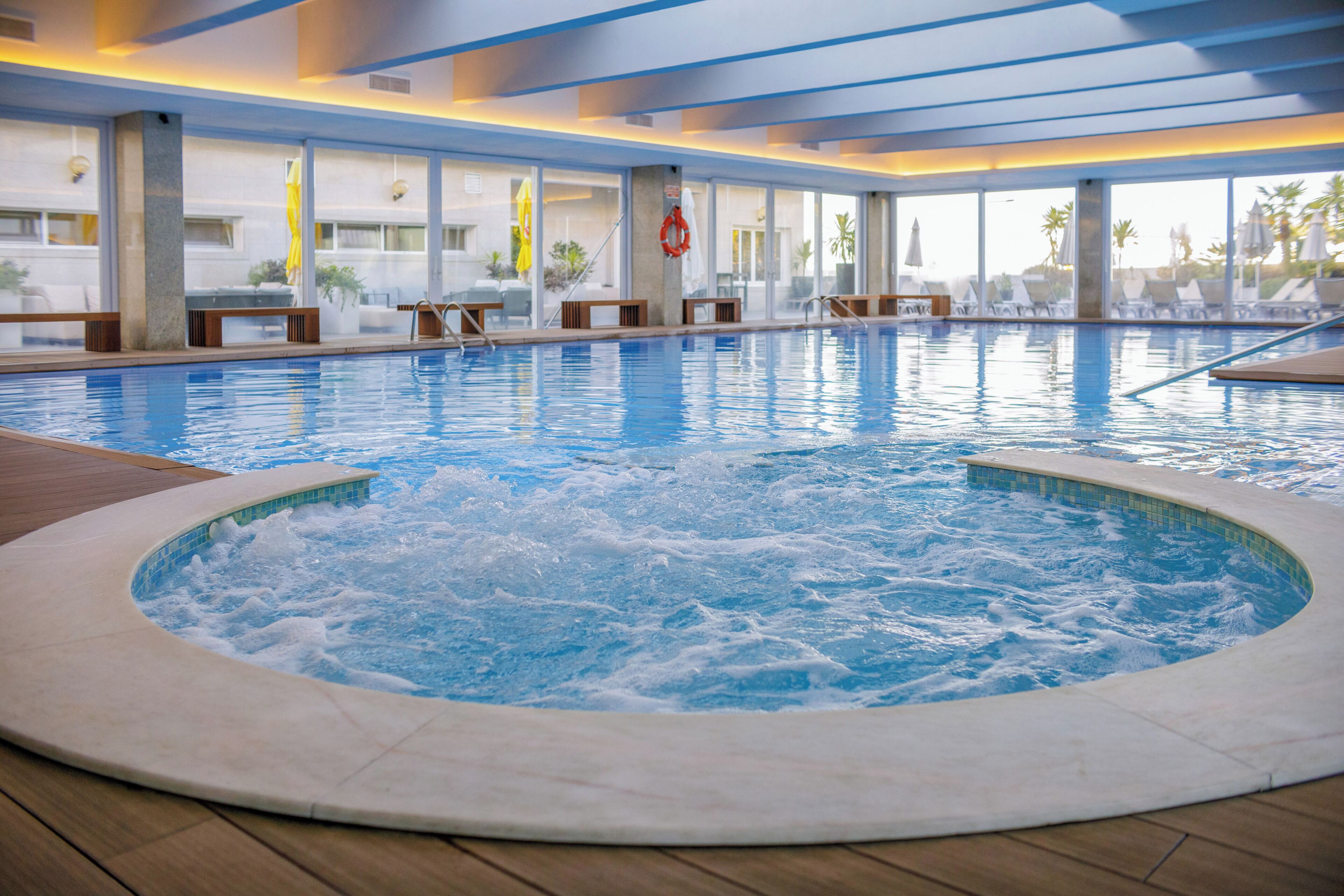 Indoor pool, open 9:00 AM to 9:00 PM, pool loungers