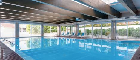 Indoor pool, open 9:00 AM to 9:00 PM, pool loungers