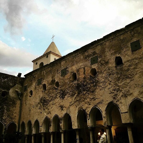 A historic building with arched windows and a bell tower.