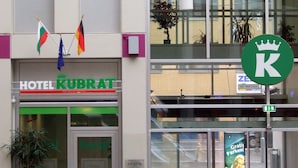 A hotel entrance with a sign reading "HOTEL KUBRAT" and flags of Germany, Austria, and Switzerland. - Kubrat In Helle Mitte (Berlin)