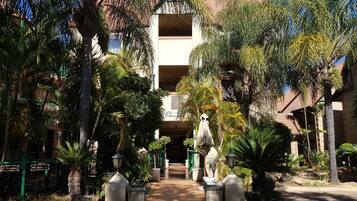 A courtyard with a central pathway leading to a building with a sign reading "Courtyard Classic."