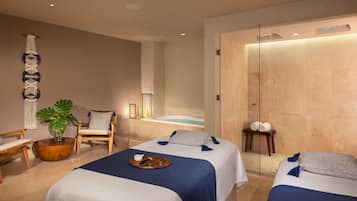 Relax in a serene space with two single beds, a side table, and a potted plant.