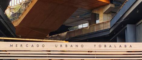 A multi-level commercial building with a prominent entrance labeled 'Mercado Urbano Tobalaba.'