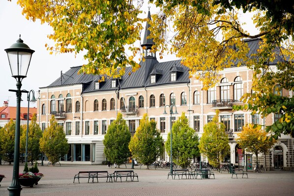 Experience the charm of this historic building, featuring a striking tower and beautifully symmetrical facade with arched windows.
