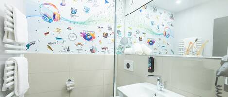 A bathroom with a white sink, toilet, and towel rack.