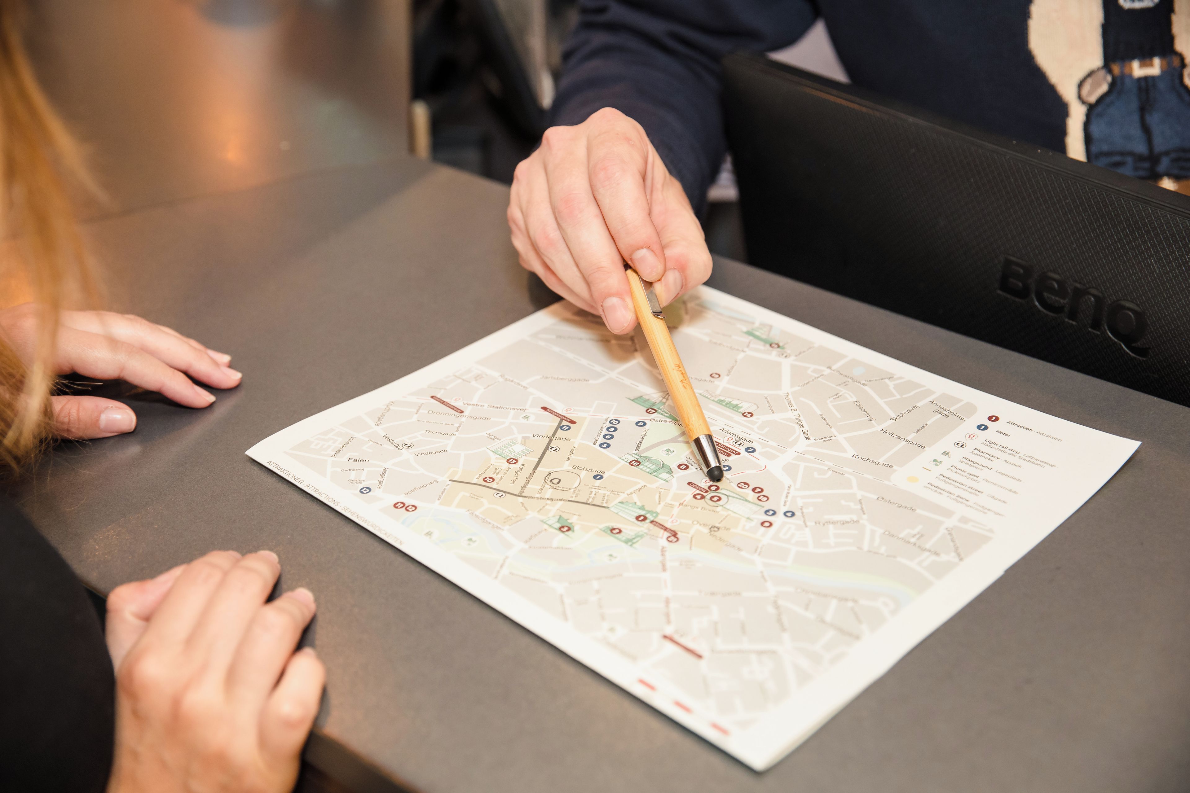 A person using a pen to mark a map.
