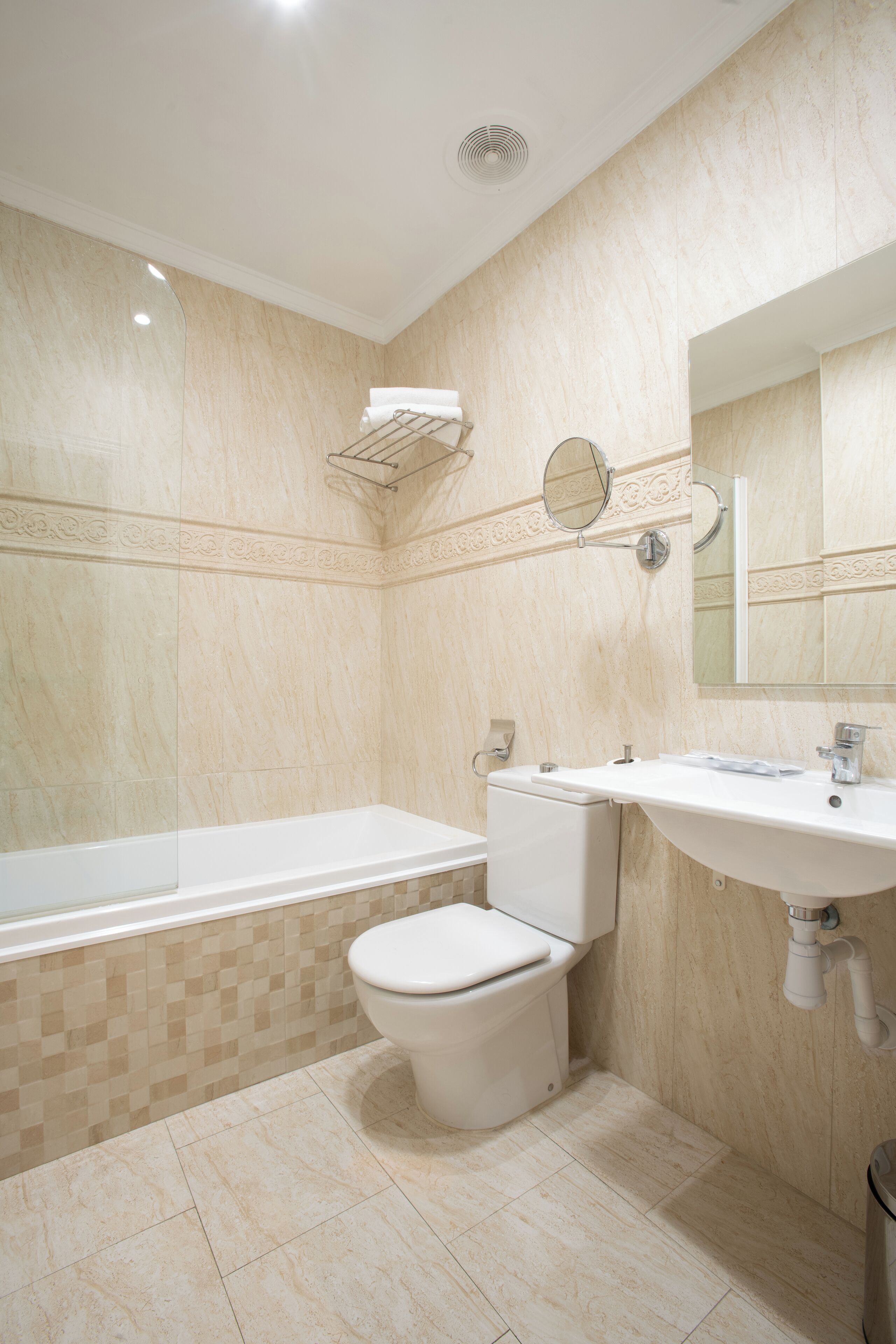 A bathroom with a bathtub, toilet, and sink.