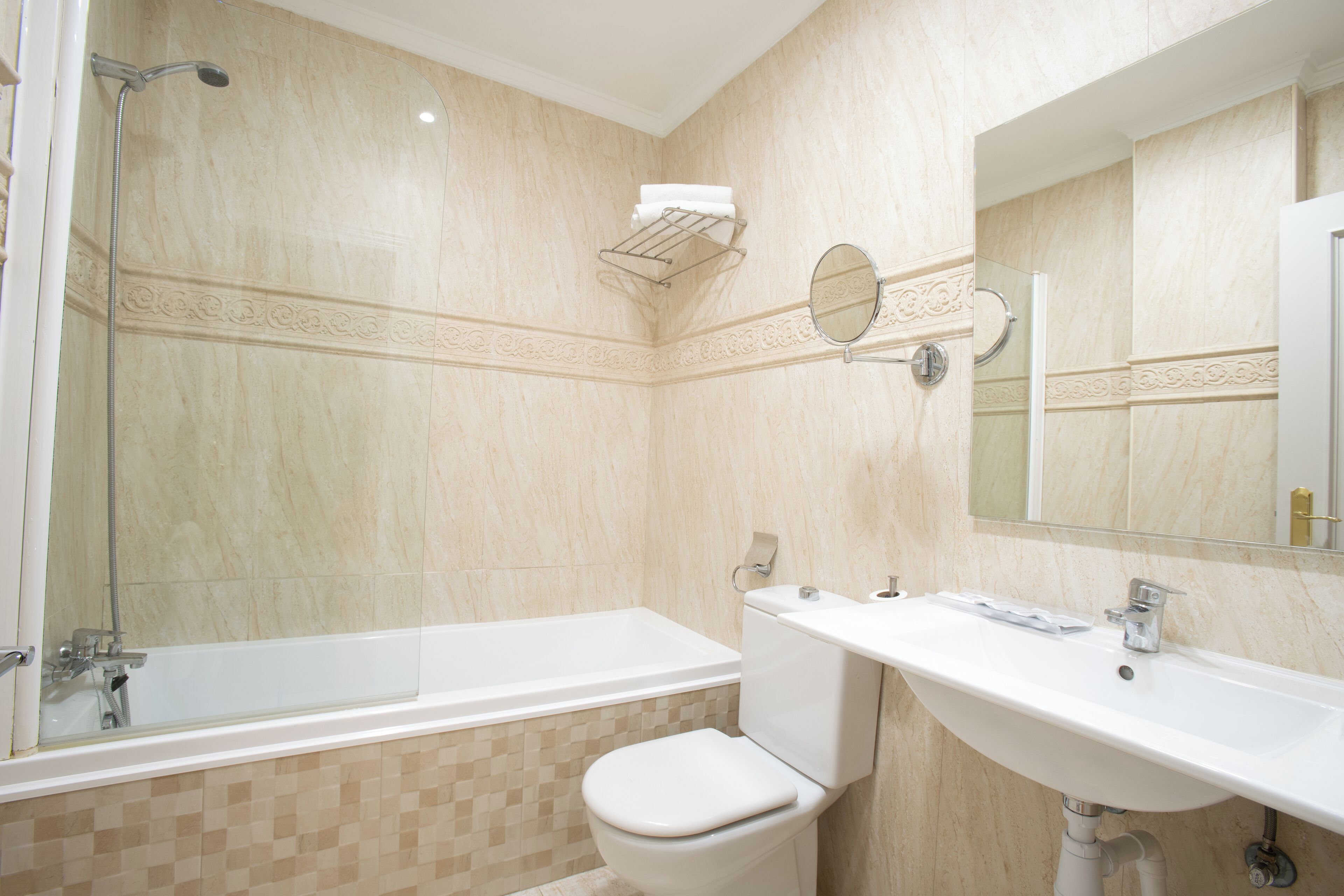 A bathroom with a bathtub, toilet, and sink.
