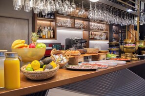 A breakfast buffet with various food items, a coffee machine, and a bar area with bottles and glasses. - Hotel Lima - Adults Recommended (Marbella)