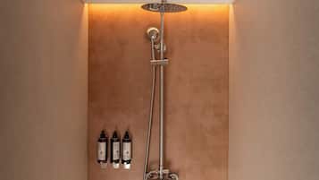 A shower with a handheld showerhead and a wall-mounted control panel.