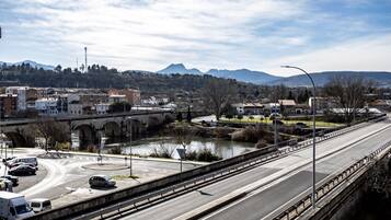 A highway overpass with a river and a bridge in the background.