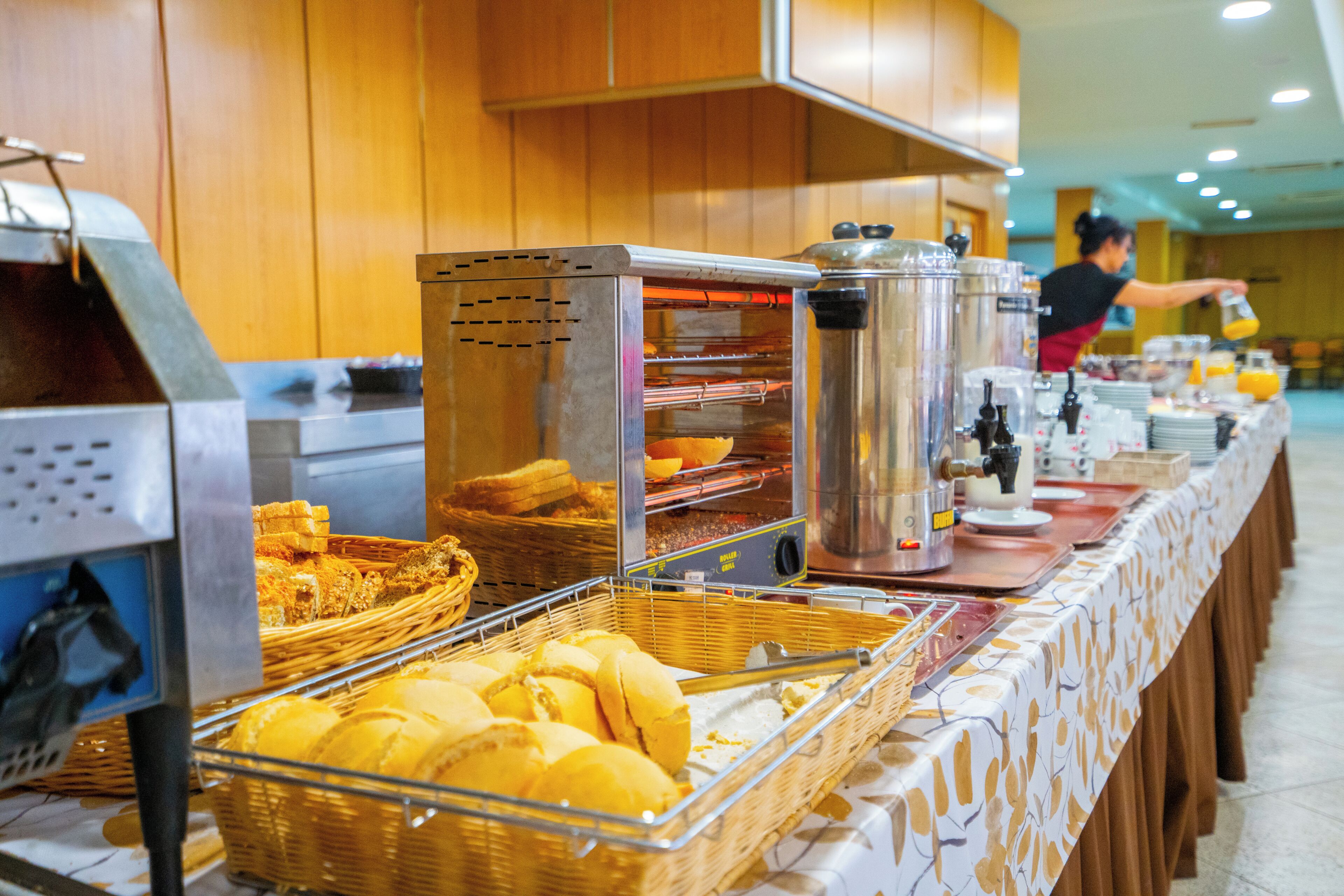 A buffet setup with various food items and a coffee station.