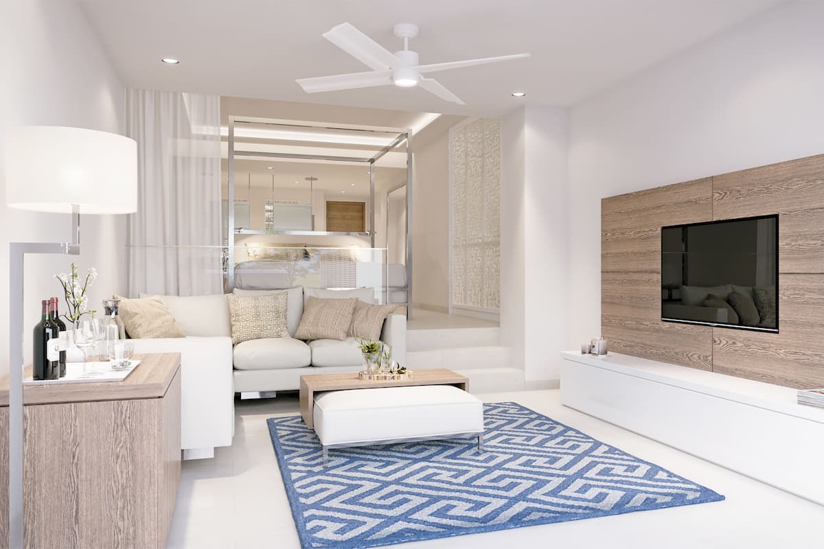 A modern living room with a sofa, coffee table, and TV mounted on a wooden wall.